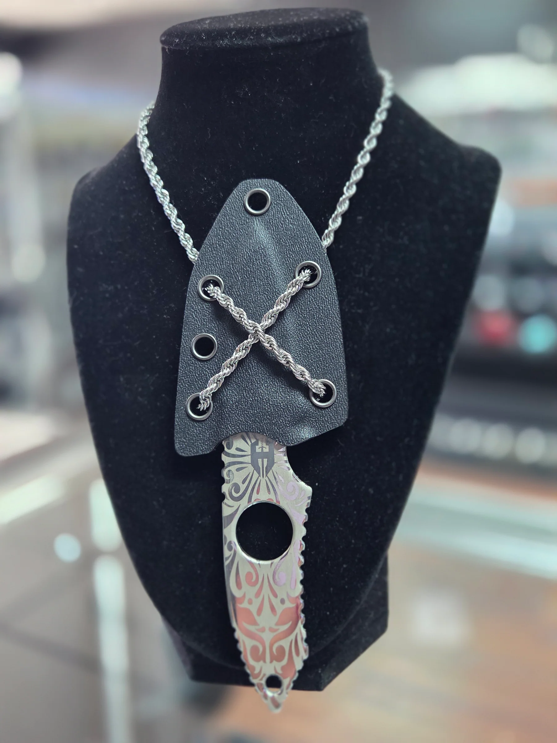 Engraved neck knife with sheath on display at Gun Boss in Bullhead City, Arizona